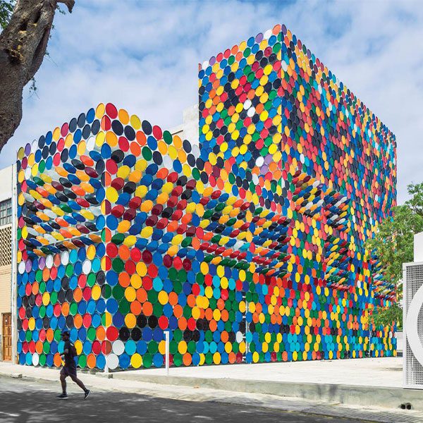 Vibrant Mosaic Façade Made of Recycled Barred Lids