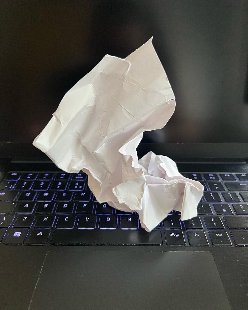 crumpled paper on laptop