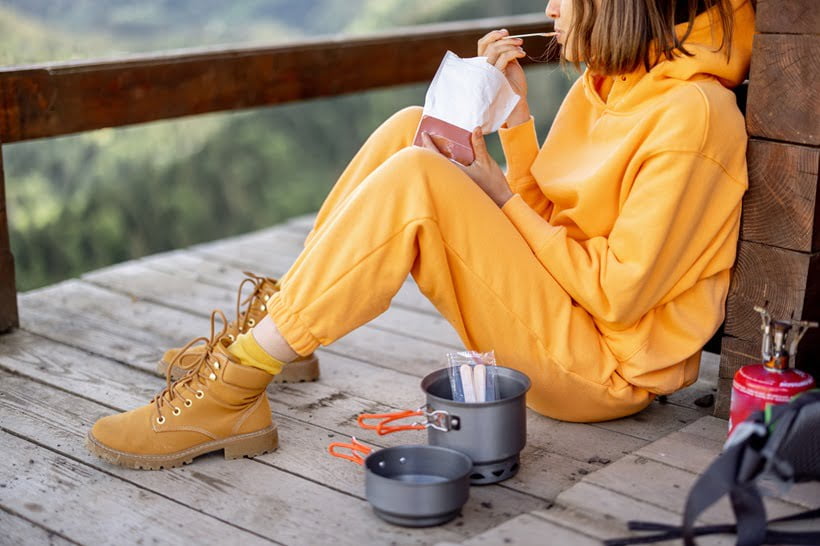 woman eating meal during camping