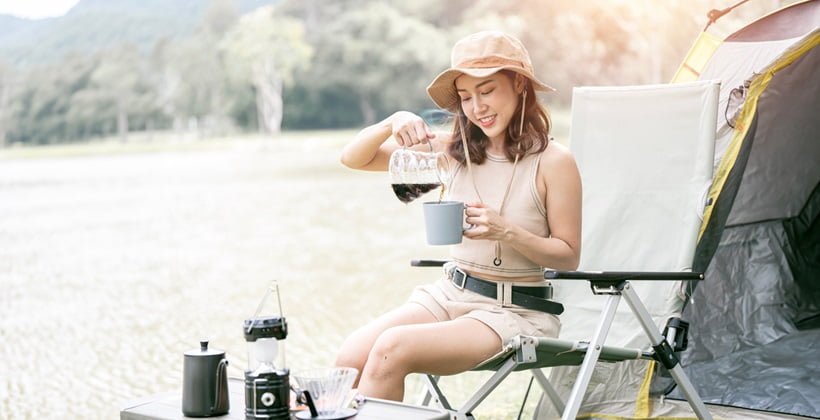 Asian woman enjoying coffe in nature