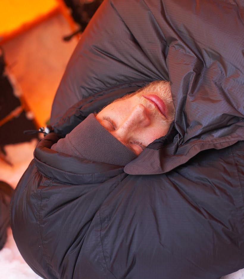 a man sleeping in a thick sleeping bag
