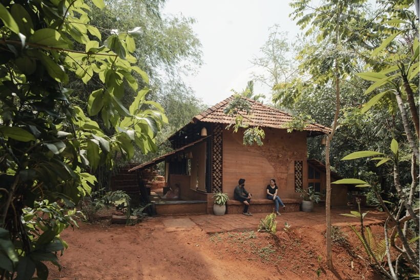 couple sitting in front of their home