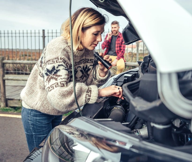a woman fixing vehicle