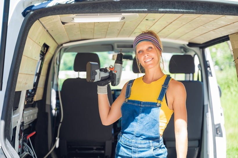 a woman holding a drill
