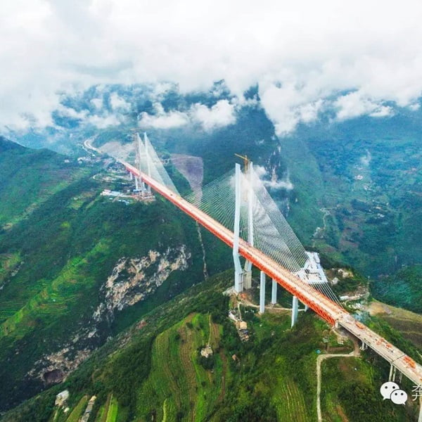 The Beipanjiang Bridge stands as a breathtaking marvel of modern engineering and design high above the dramatic landscapes of China.