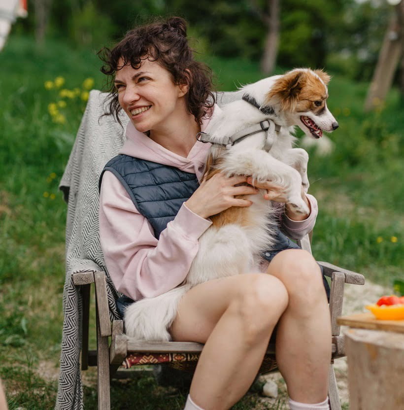 a dog sitting on a woman's lap