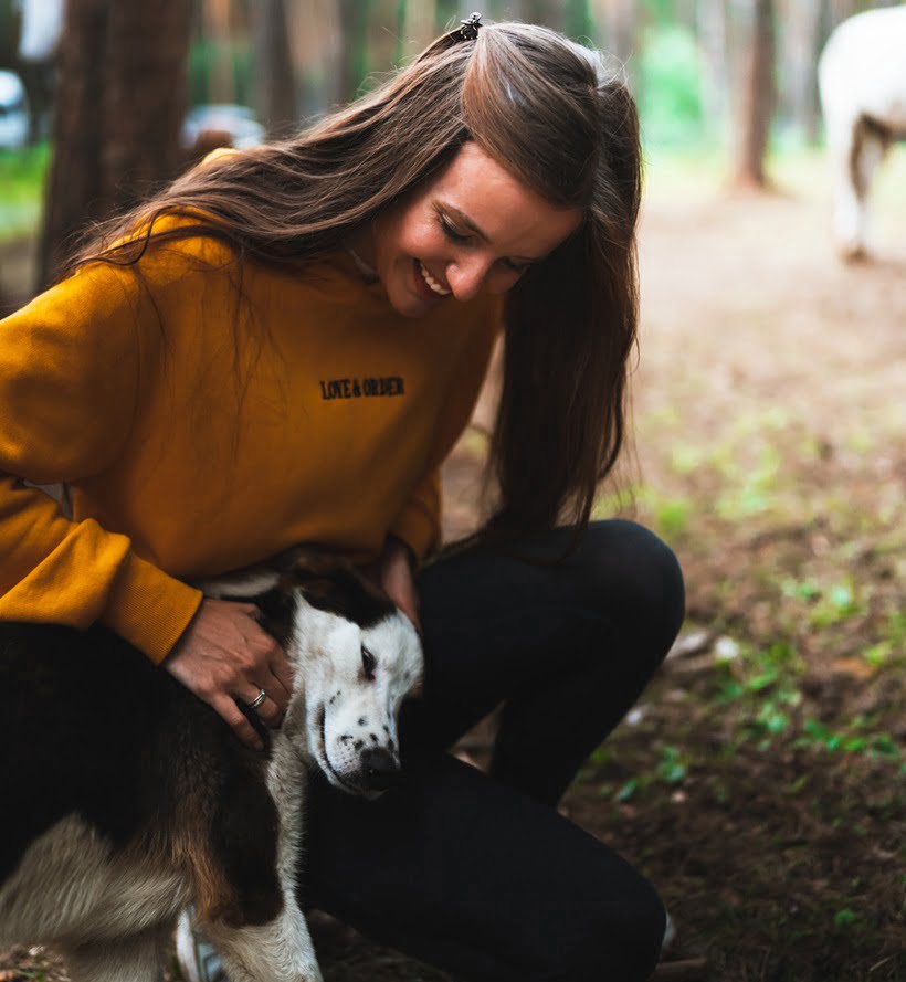 a woman smiling to her dog