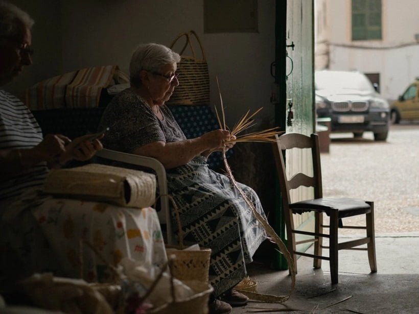 a woman knitting a lampshade
