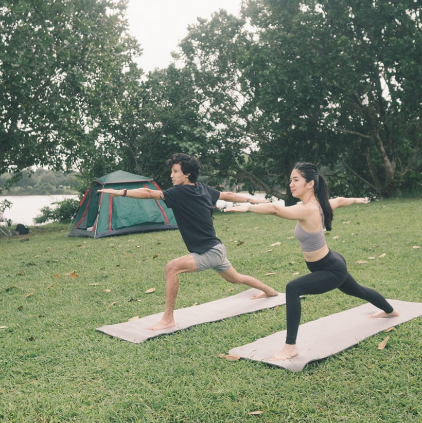 couple doing yoga whenn camping