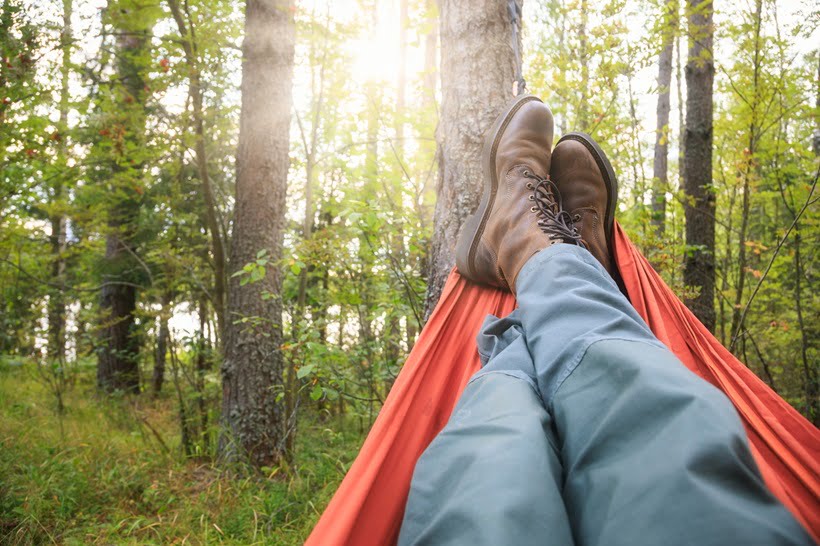 a man resting on a hammock