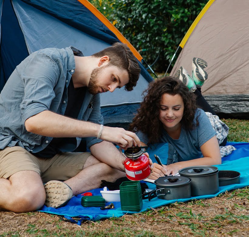couple cooking in the outdoors