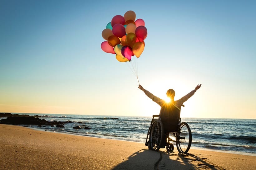 a man on a wheelchair enjoying beach