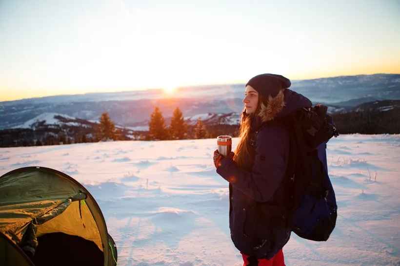 a woman camper watching sunrise