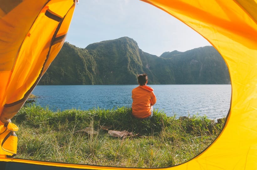 woman sitting near lake