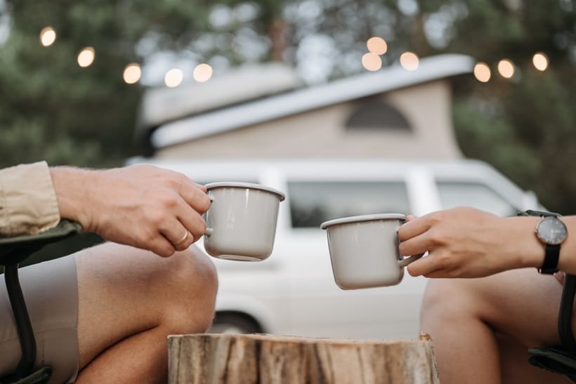 a couple drinking coffee during camping