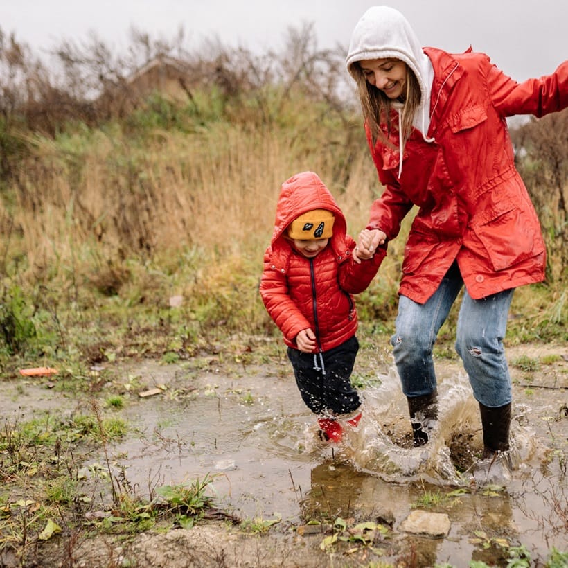a mother and her sun playing in the rain