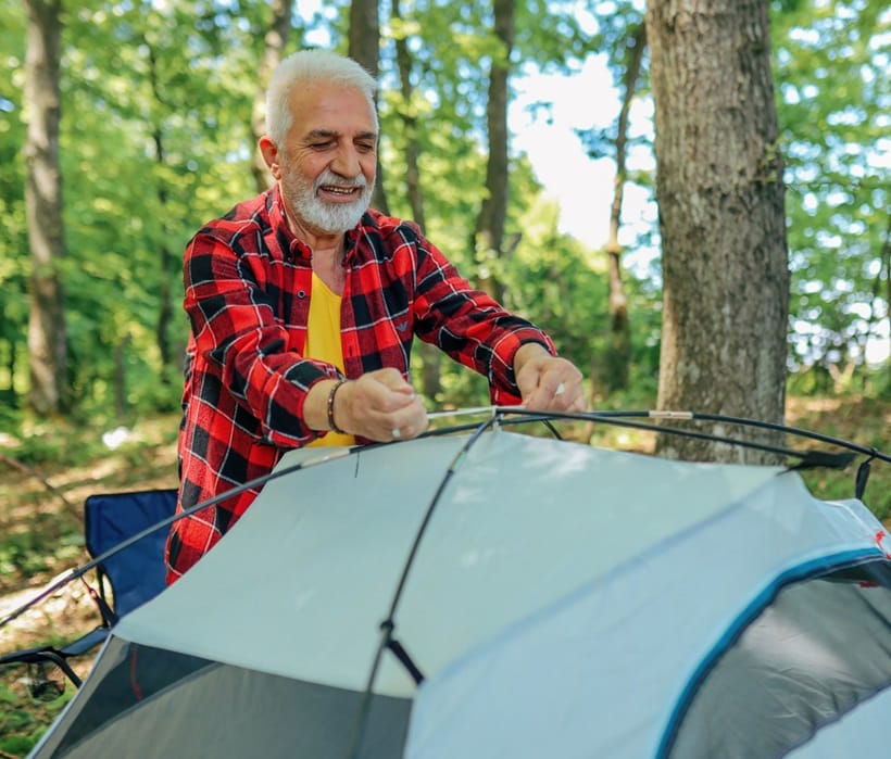 a senior pitching his tent