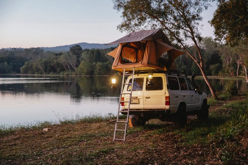 a van parked next to a lake