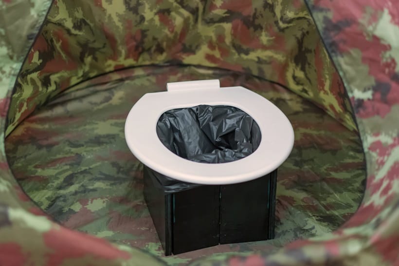 portable toilet in a tent