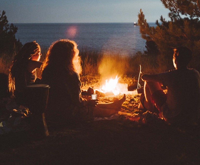 youngsters having fun by the campfire