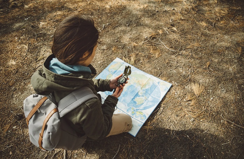 a hiker using a compass