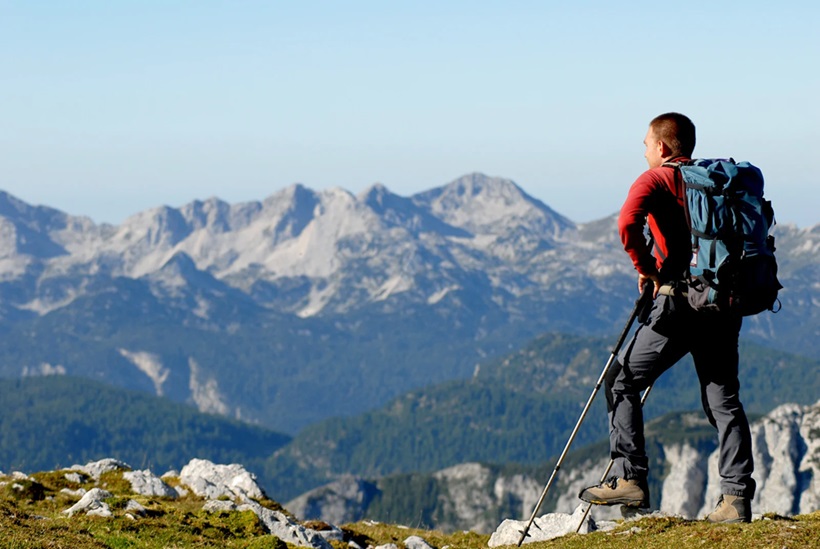 a man standing on the top of a hill