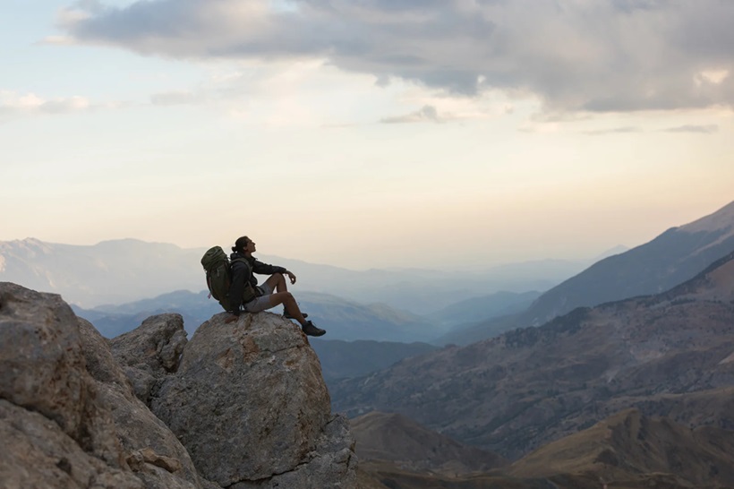 a backpacker on the top of a hill