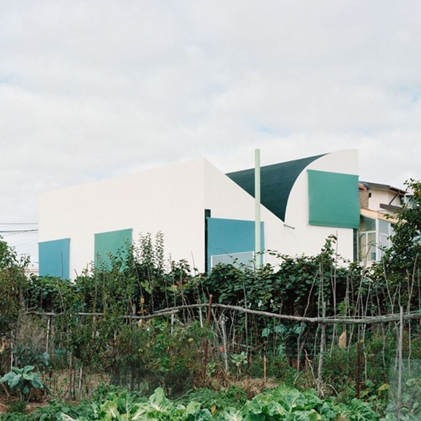 Fala Atelier inverted roof house has both a sloped and curved roofline that creates a unique and instantly recognizable silhouette.