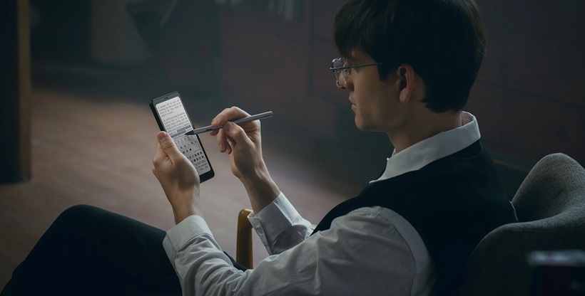 a man writing stg on his tablet